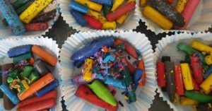 trozos de ceras de colores en moldes de hornear de muffins