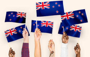 varias manos sosteniendo banderas de Nueva Zelanda